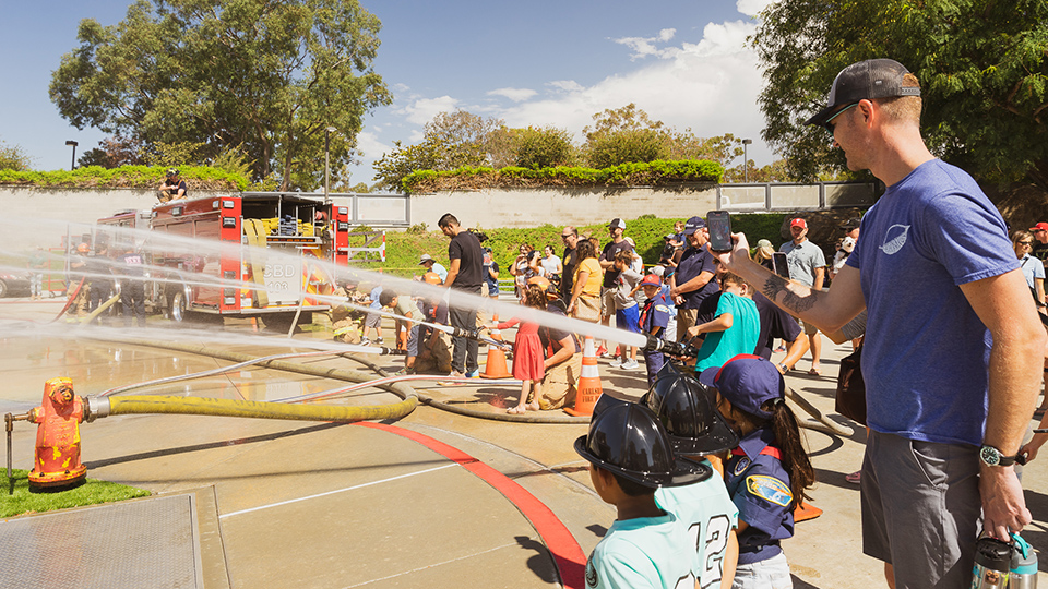 Fire hose demonstration with kids