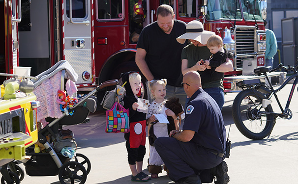 Firefighter with kids at Public Safety Open House
