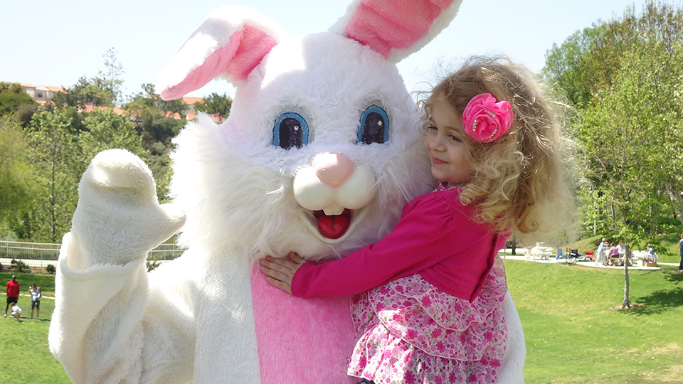 Bunny character holding child